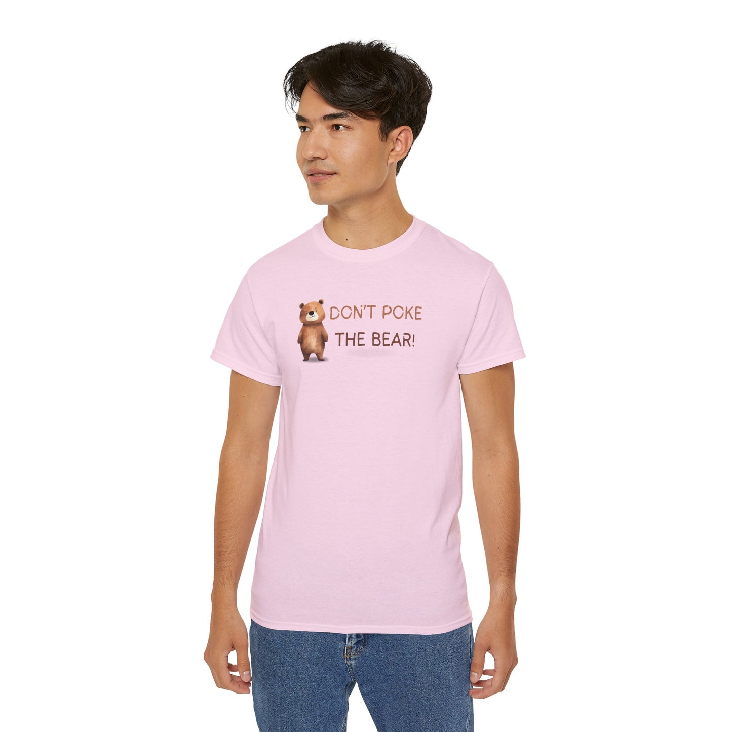 Person wearing a pink t-shirt with a bear graphic and text on a white background