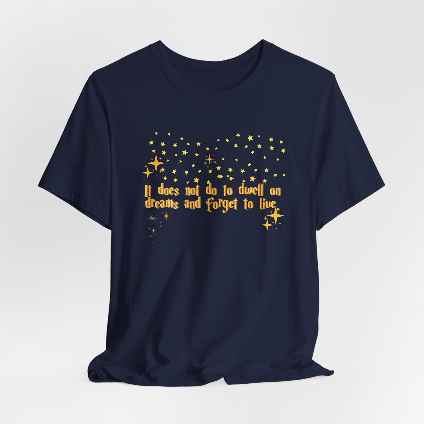 Navy blue t-shirt with gold text and star graphics on a light gray background, Dumbledore quote, harry potter