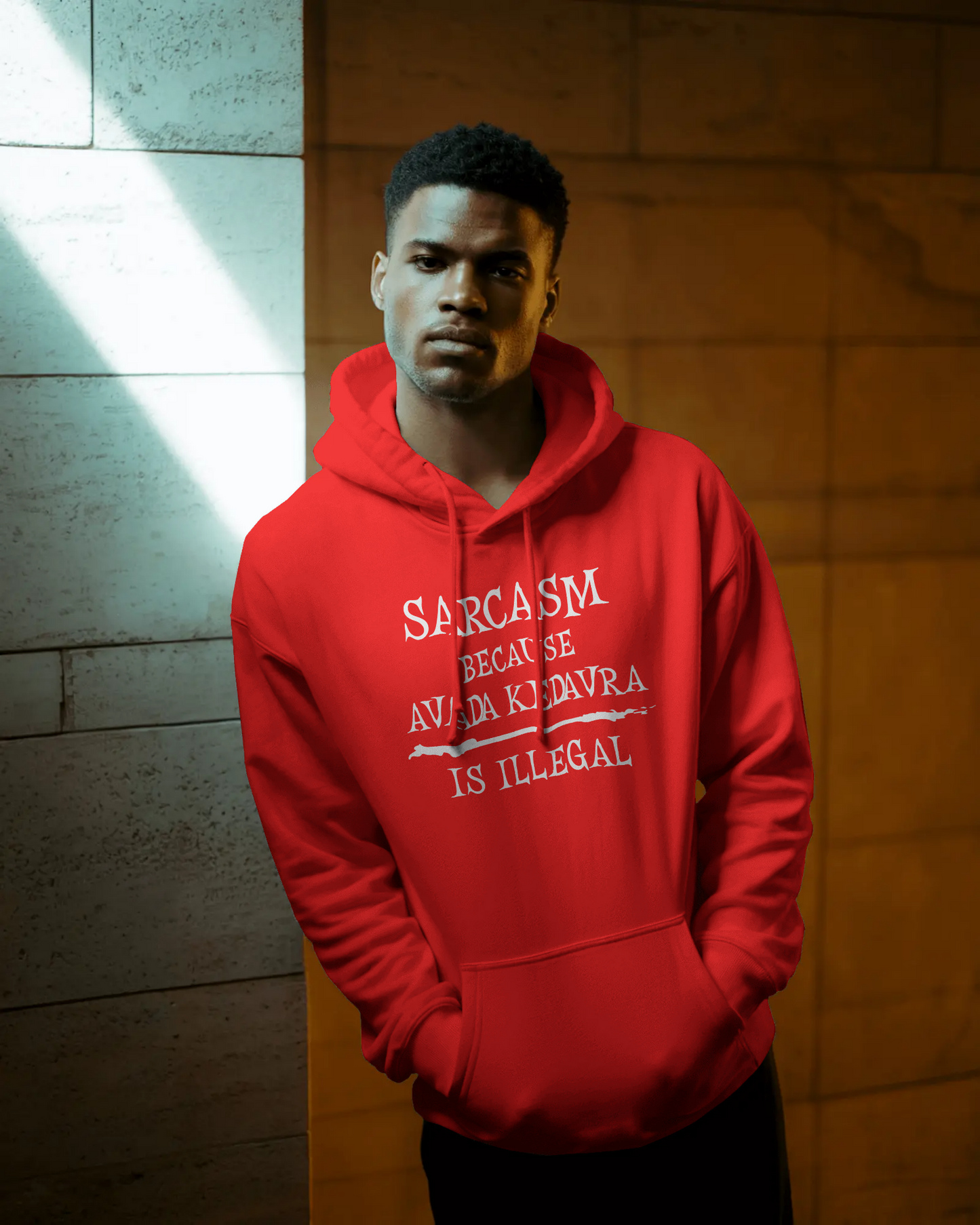 Person wearing a red hoodie with text, standing against a textured wall.  Sarcasm, Sarcastic Humor, Harry Potter, potterhead, avada kedavra