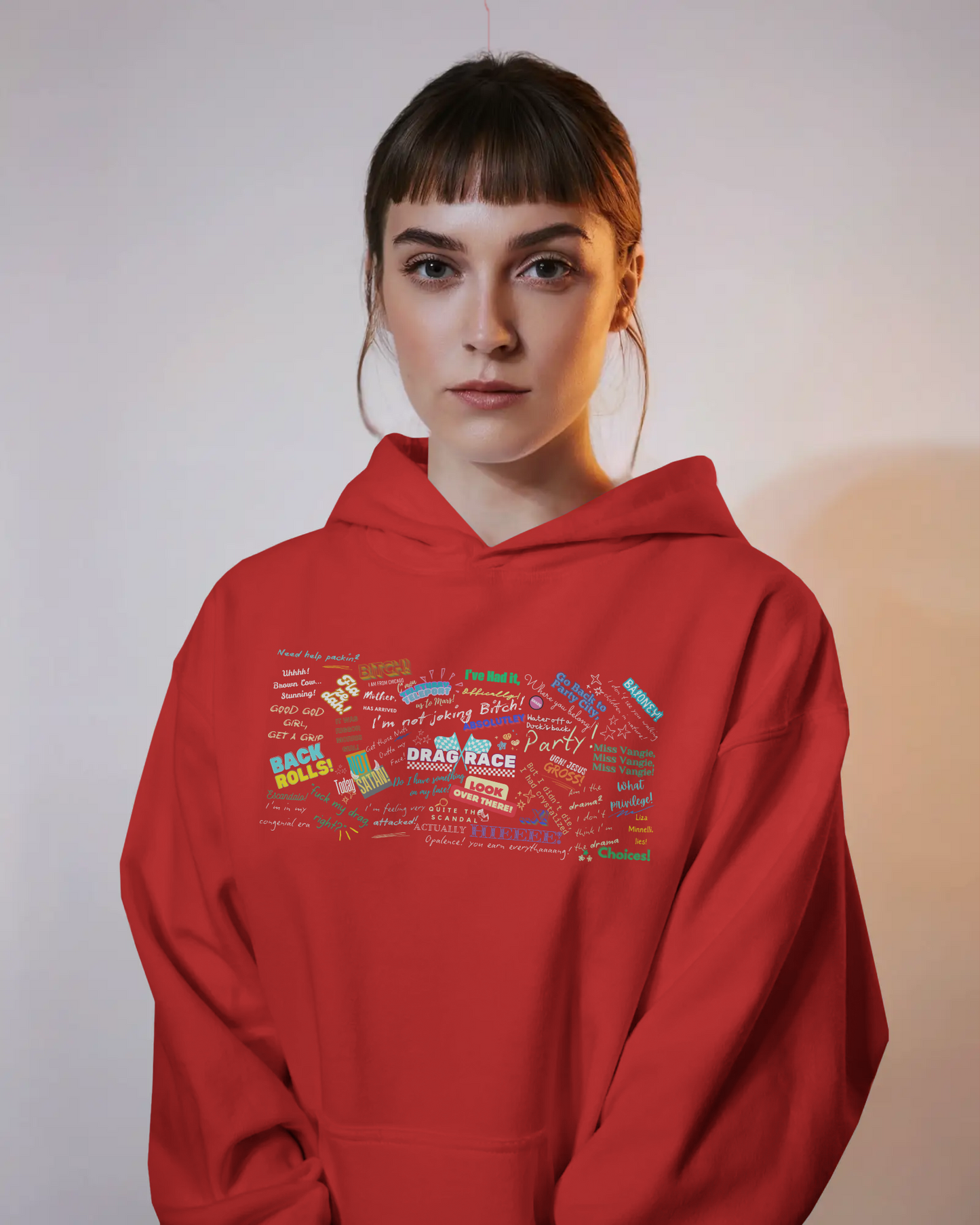 Person wearing a red hoodie with colorful text design on a plain background Drag race, Rupaul, Rupaul's Drag Race UK, LGBT, Queer Culture, Gay, Drag Queen