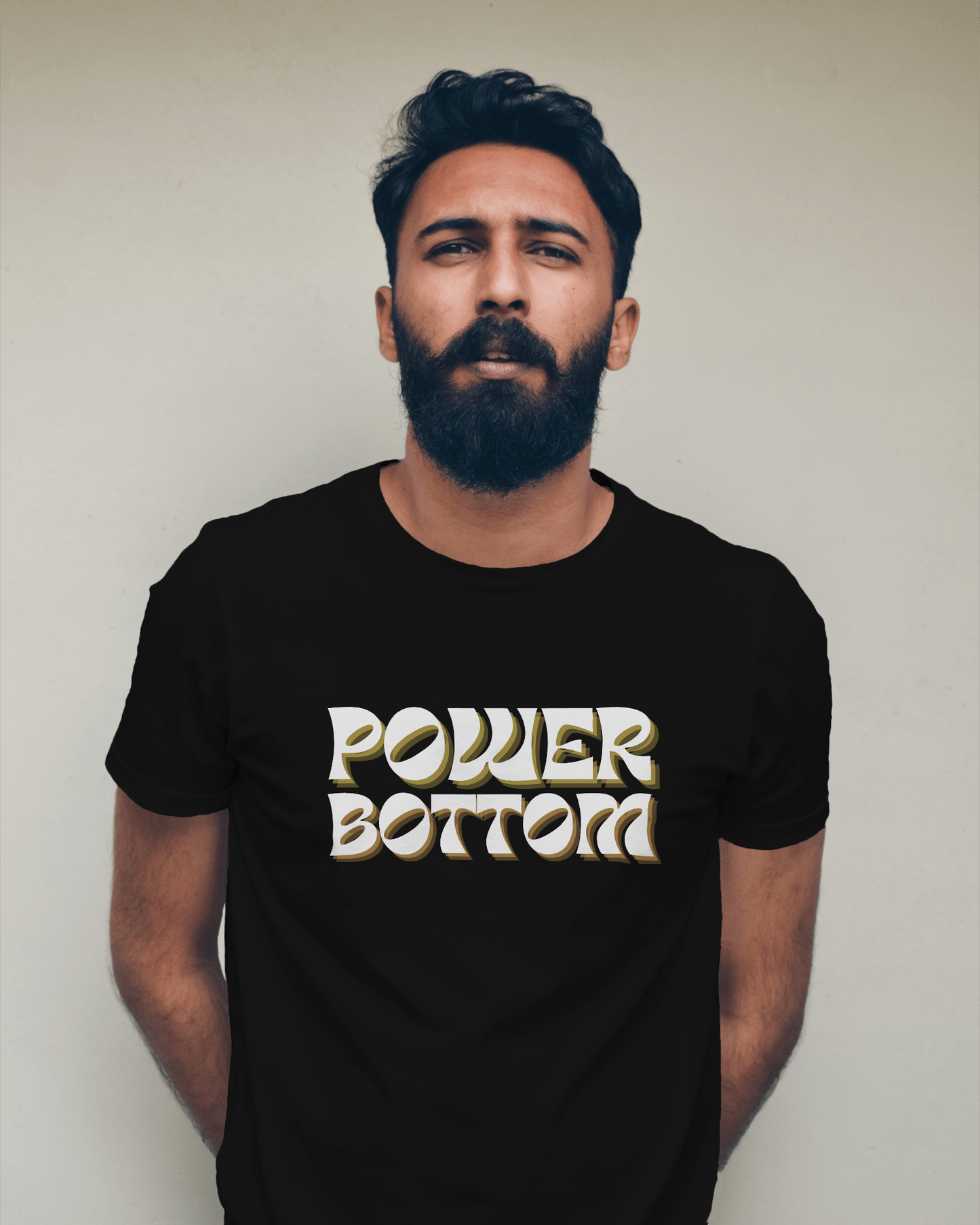 Man wearing a black t-shirt with 'POWER BOTTOM' text against a plain background Kink, LGBTQIA+, Queer Sub Dom