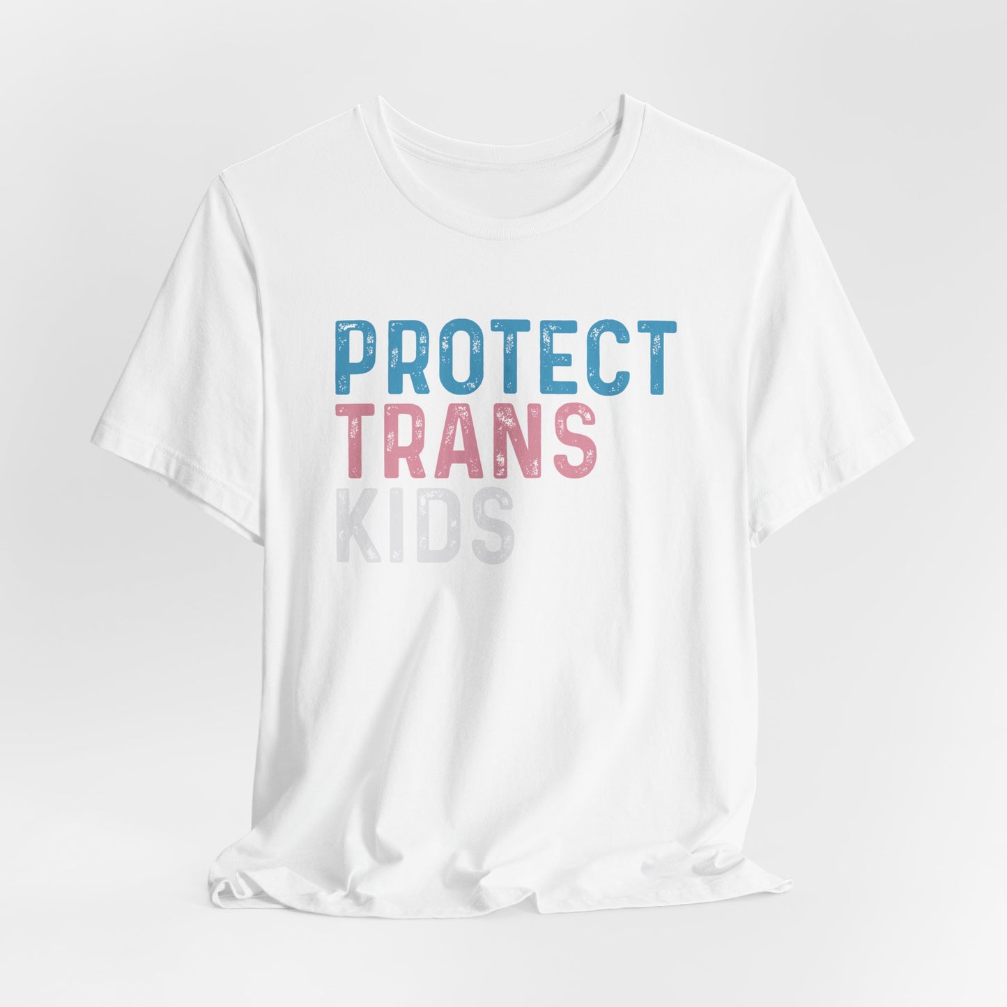 White t-shirt with 'PROTECT TRANS KIDS' text on a light gray background LGBTQIA+, Queer, Trans rights