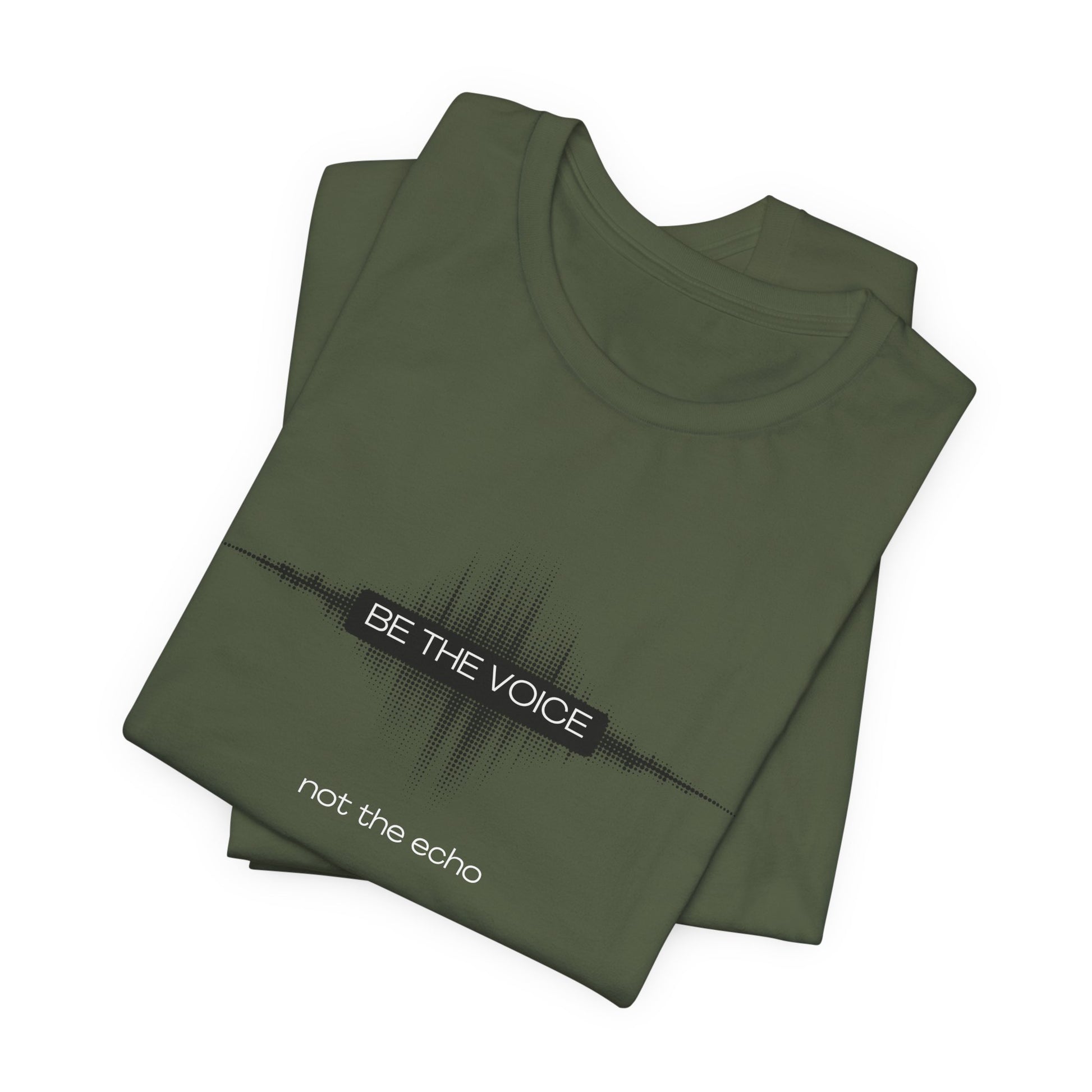 Folded green t-shirt with text 'Be the voice not the echo' on a white background