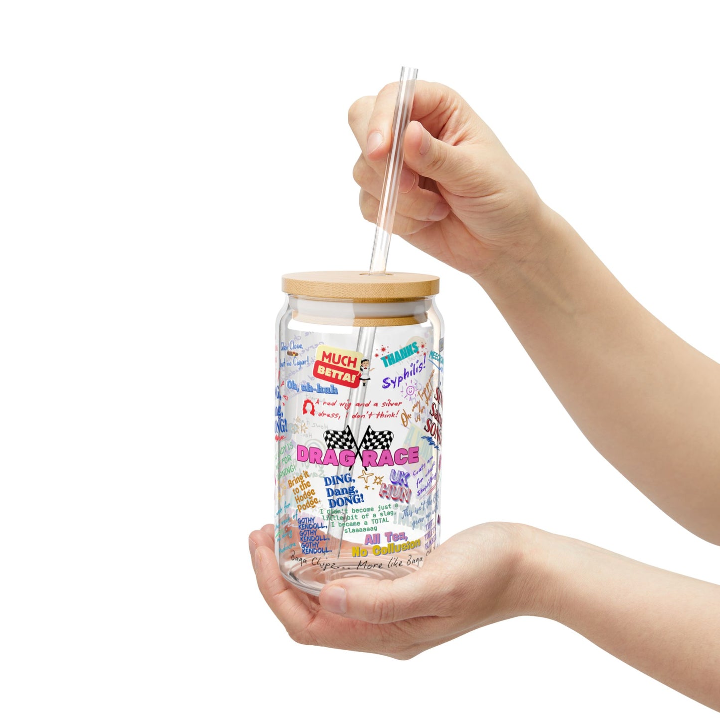 Glass tumbler with a wooden lid and colorful text design held by a hand on a white background Features iconic Quotes from your favorite Drag Race UK  Drag Queens.