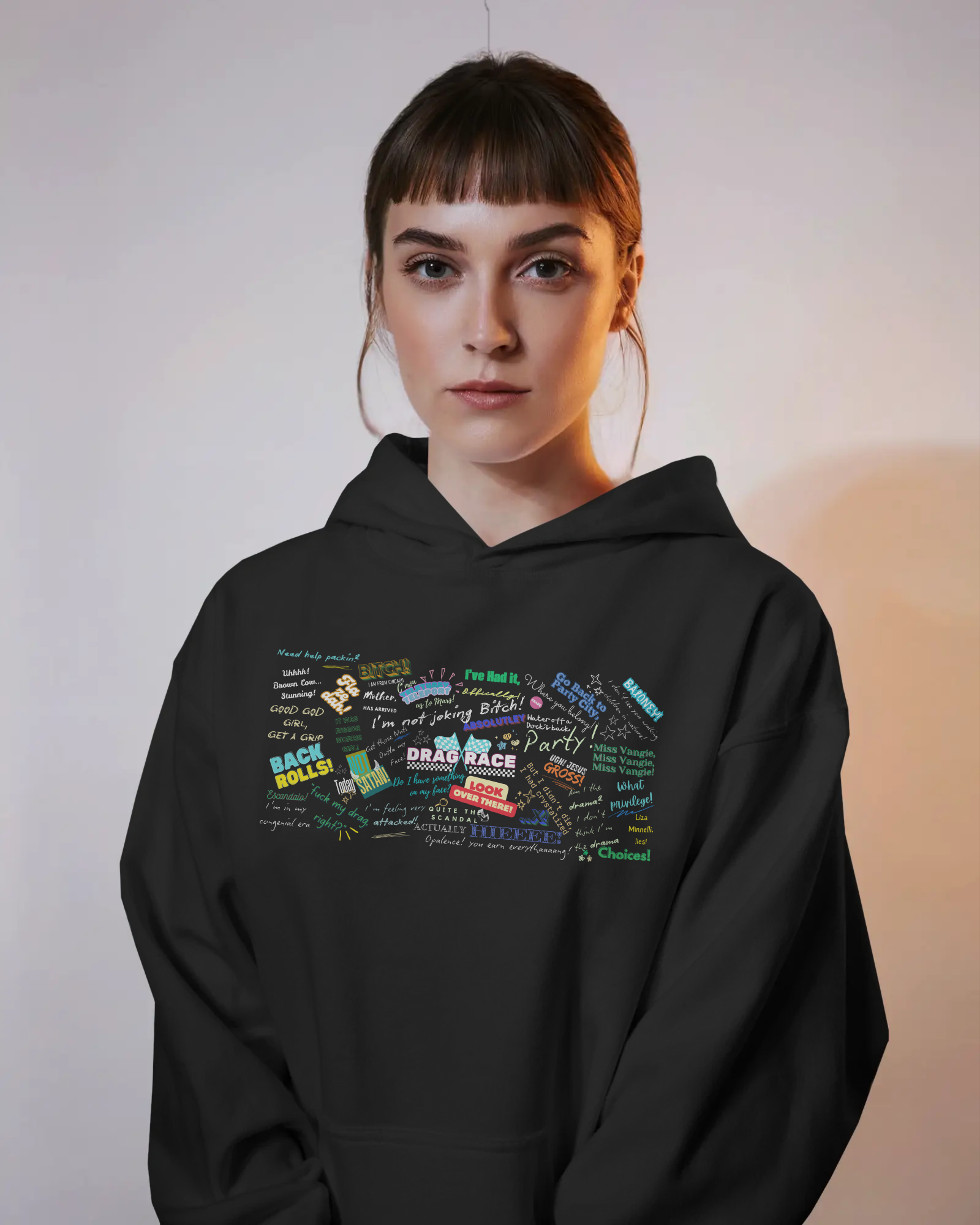 Person wearing a black hoodie with colorful text design on a plain background  Drag race, Rupaul, Rupaul's Drag Race UK, LGBT, Queer Culture, Gay, Drag Queen