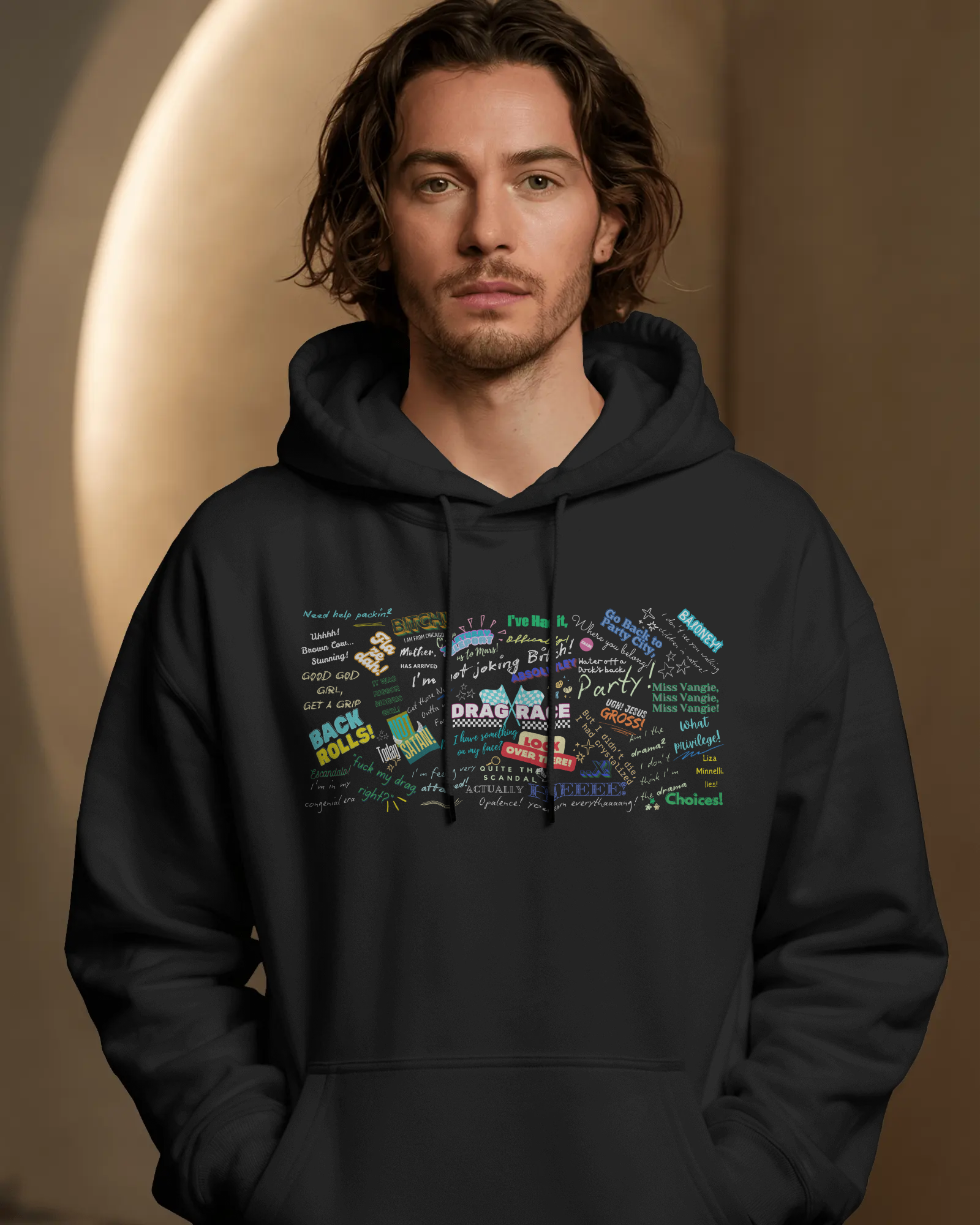 Man wearing a black hoodie with colorful graphic design on a brown background  Drag race, Rupaul, Rupaul's Drag Race UK, LGBT, Queer Culture, Gay, Drag Queen