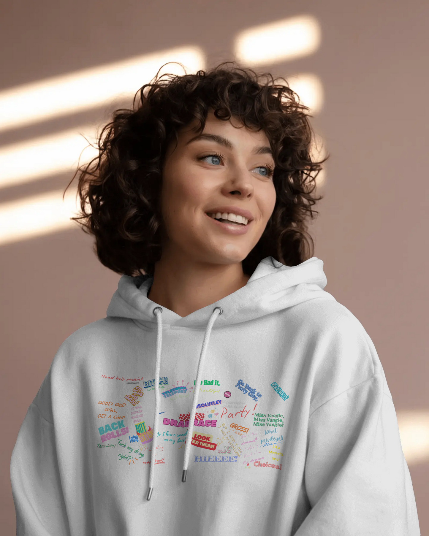 Person wearing a light gray hoodie with colorful text design against a beige background  Drag race, Rupaul, Rupaul's Drag Race UK, LGBT, Queer Culture, Gay, Drag Queen