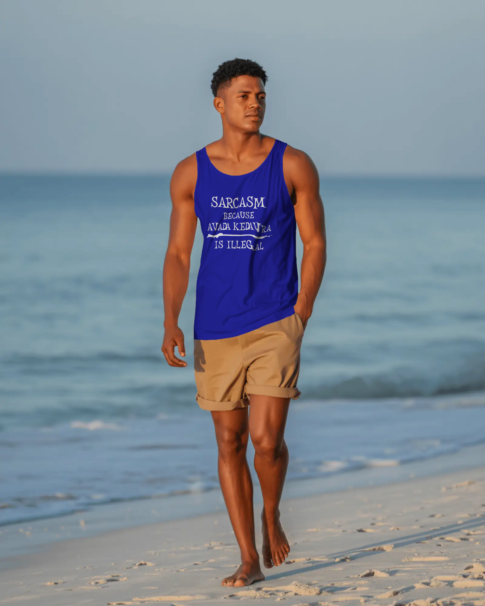 Man walking on a beach wearing a blue tank top with text and beige shorts. Sarcasm, Sarcastic Humor, Harry Potter, Potter head, Avada Kedavra