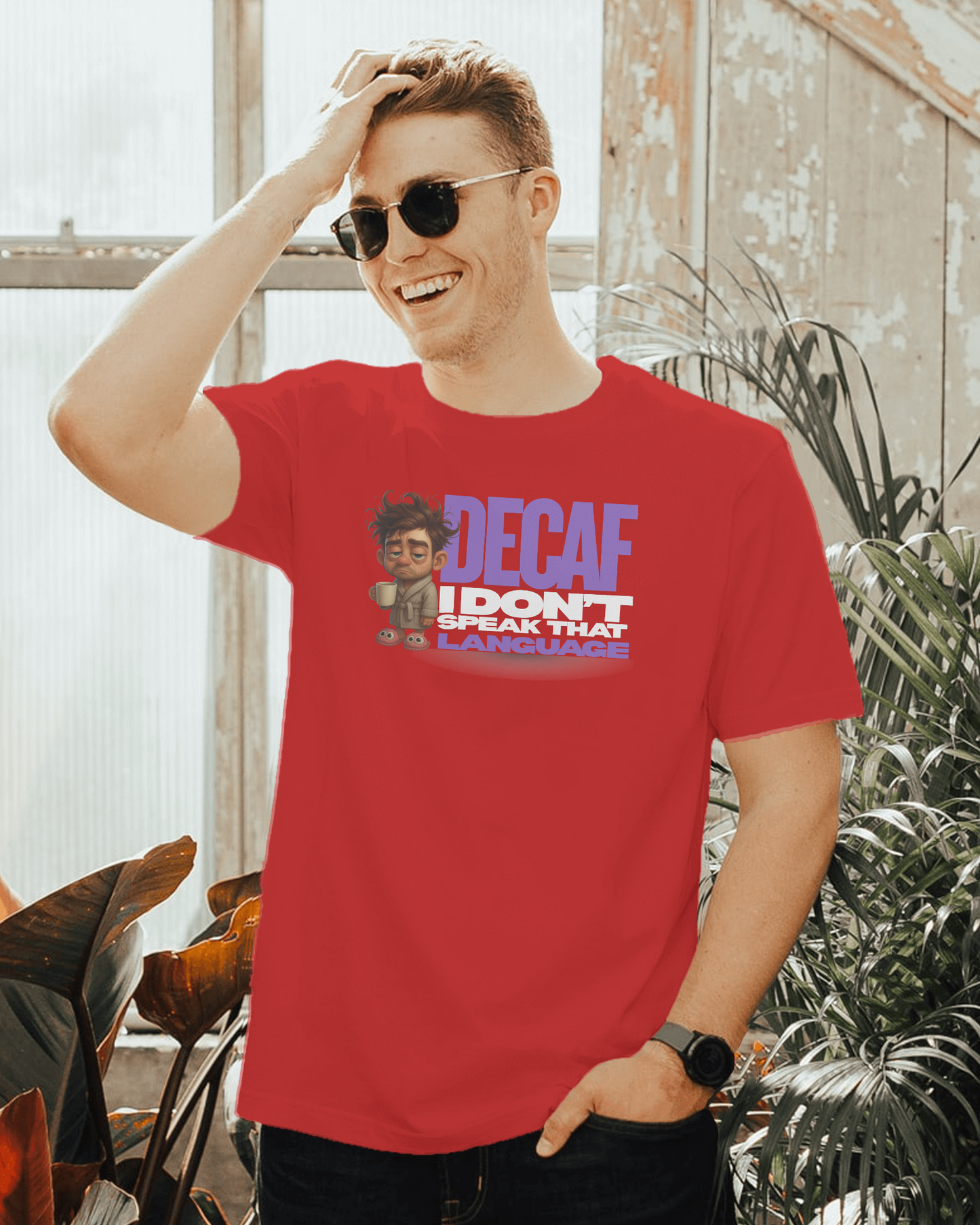 Man wearing a red t-shirt with a graphic design and text, standing outdoors.