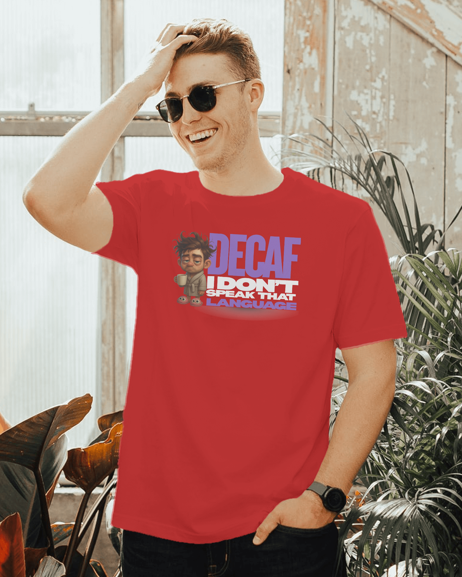 Man wearing a red t-shirt with a graphic design and text, standing outdoors.