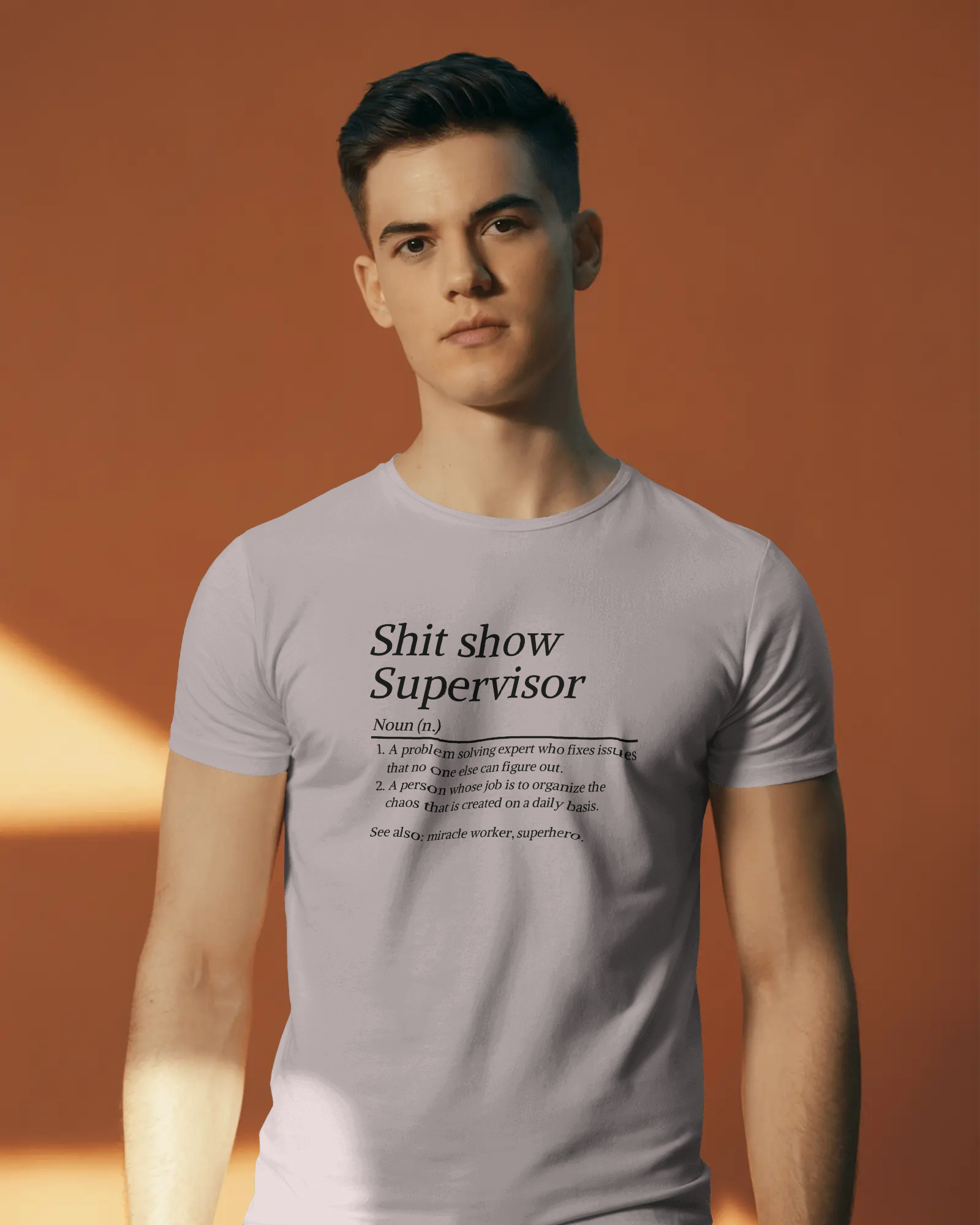 Man wearing a t-shirt with text design against an orange background