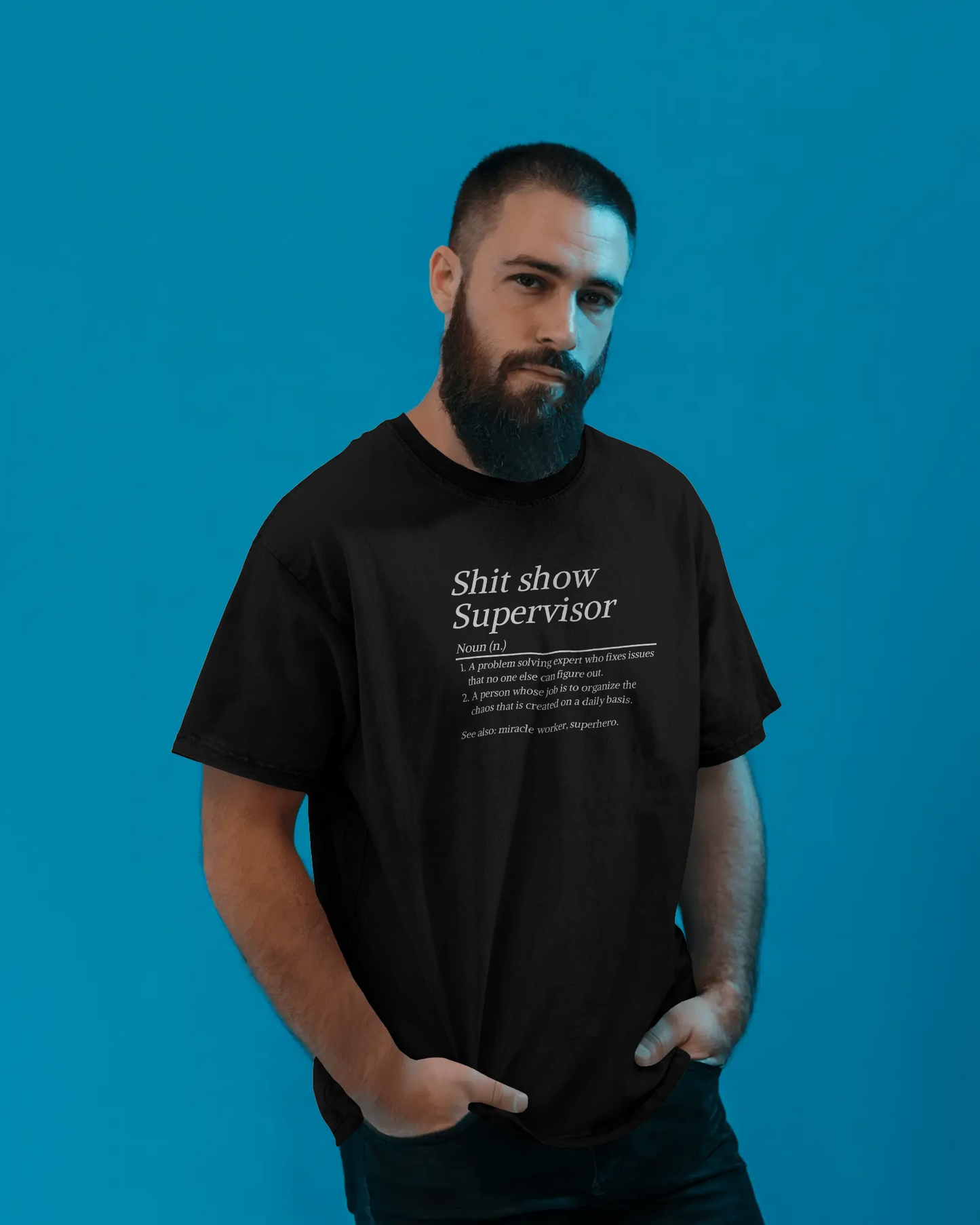 Man wearing a black t-shirt with text against a blue background