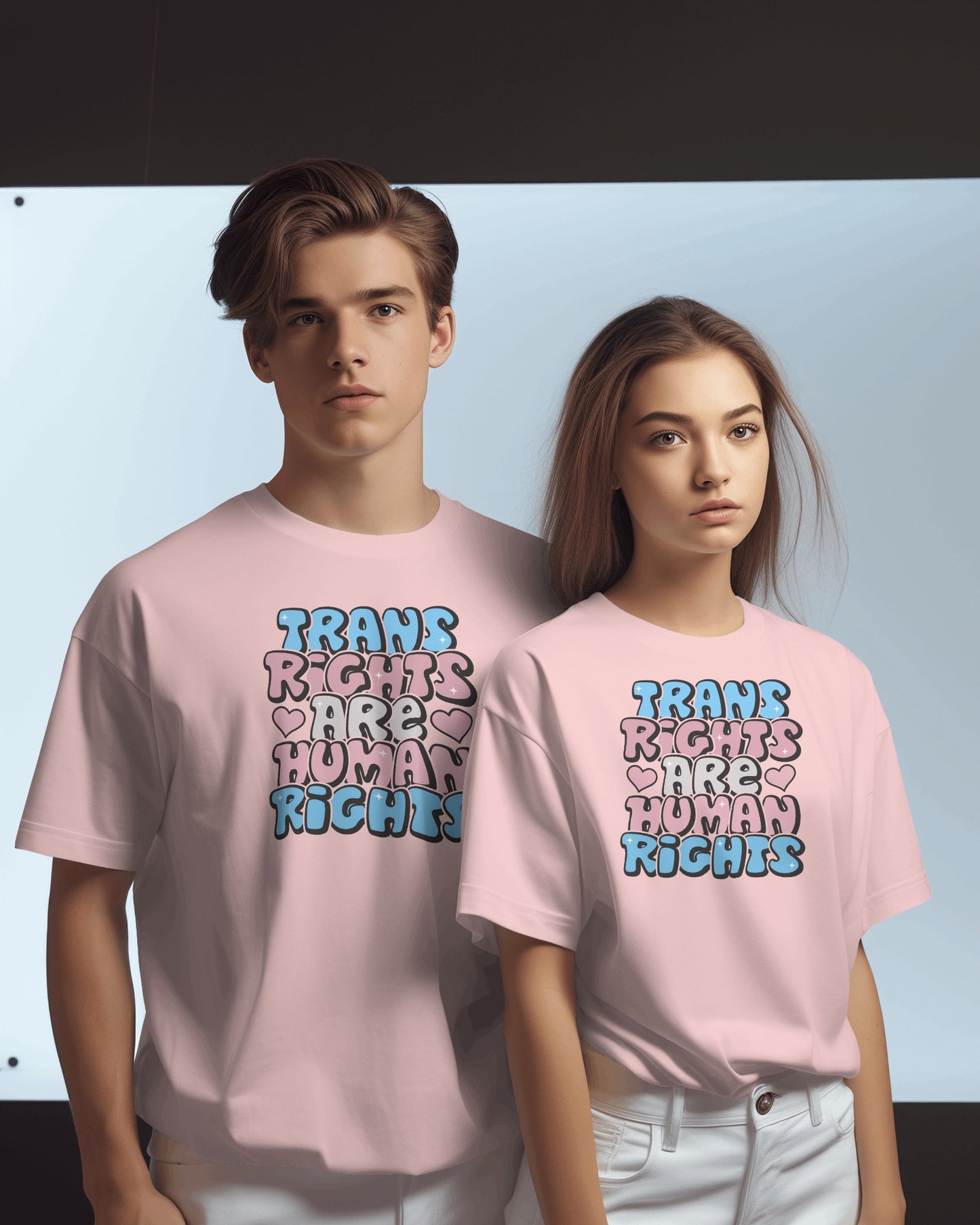 Two people wearing pink t-shirts with 'Trans Rights Are Human Rights' text. LGBTQIA+, Queer, Trans rights