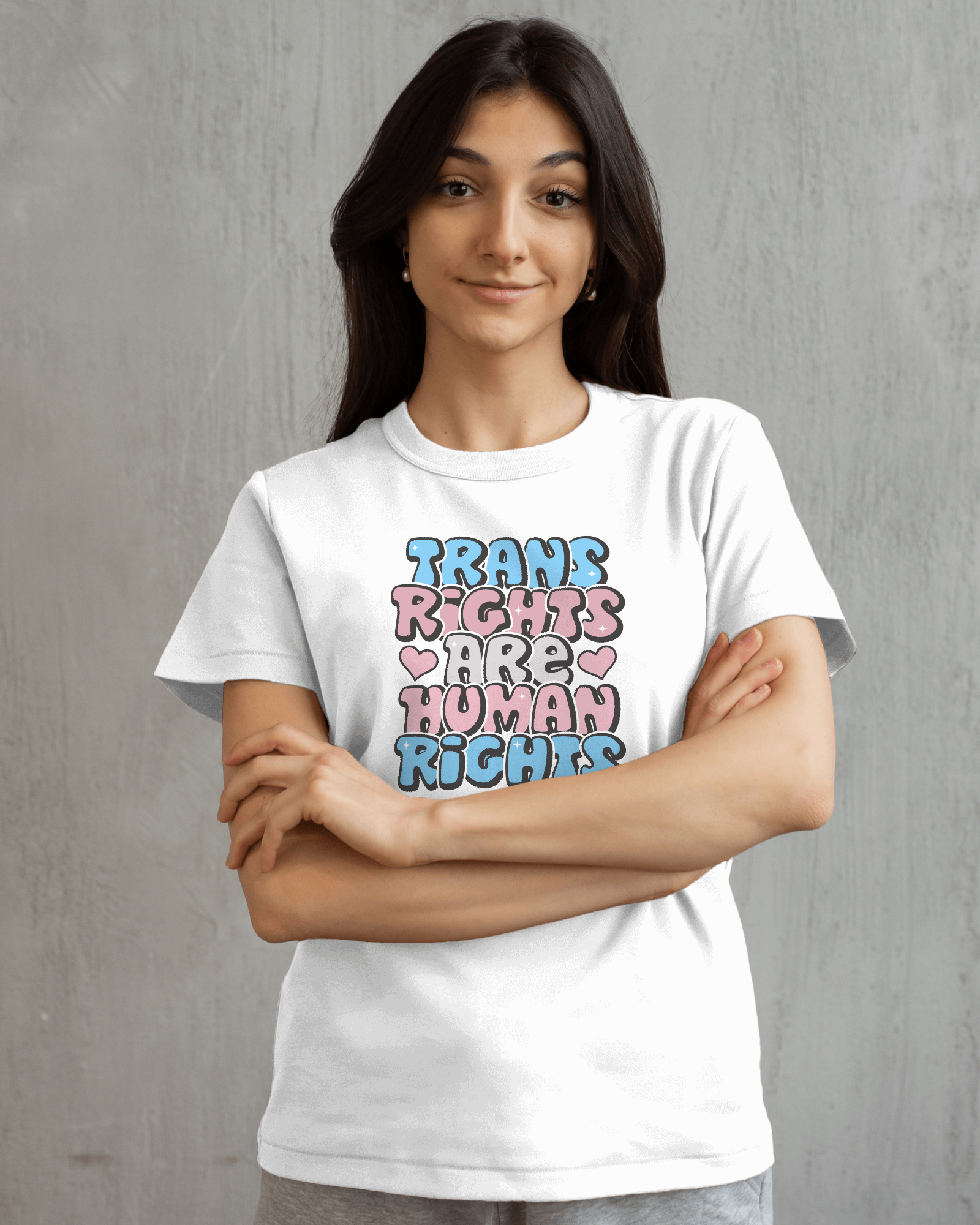 Person wearing a white t-shirt with 'Trans Rights Are Human Rights' text on a gray background LGBTQIA+, Queer, Trans rights