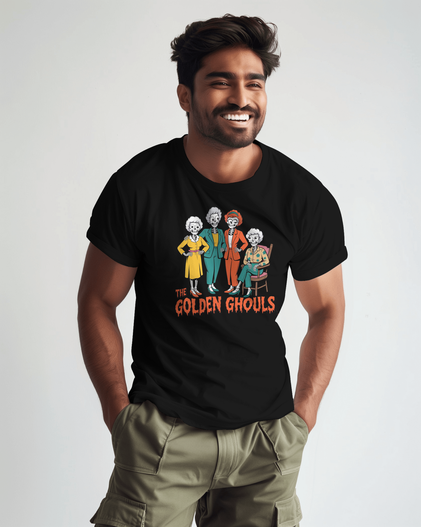 Man wearing a black t-shirt with 'The Golden Ghouls' graphic design on a plain background   Golden Girls, 80s TV, Halloween Tees