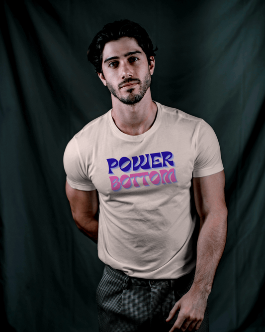 Man wearing a beige t-shirt with 'POWER BOTTOM' text against a dark background Kink, LGBTQIA+, Queer Sub Dom 