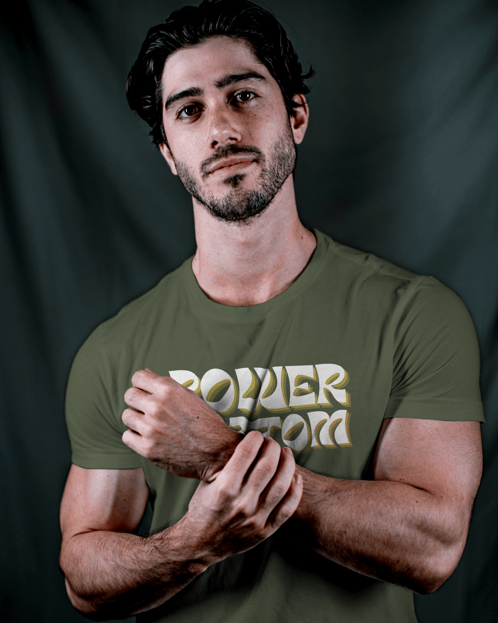 Man wearing a green t-shirt with 'POWER WORD' text against a dark backgroundKink, LGBTQIA+, Queer Sub Dom 