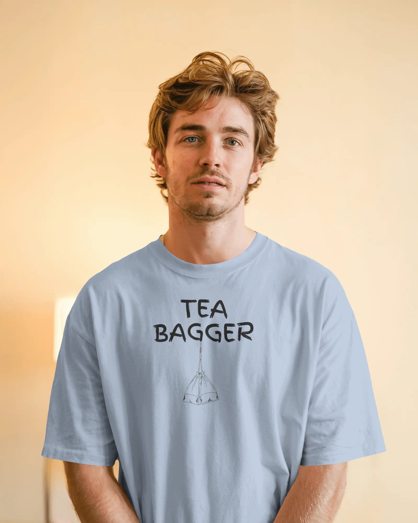 Man wearing a light blue t-shirt with 'TEA BAGGER' text on a gradient background  Kink, LGBTQIA+, Queer