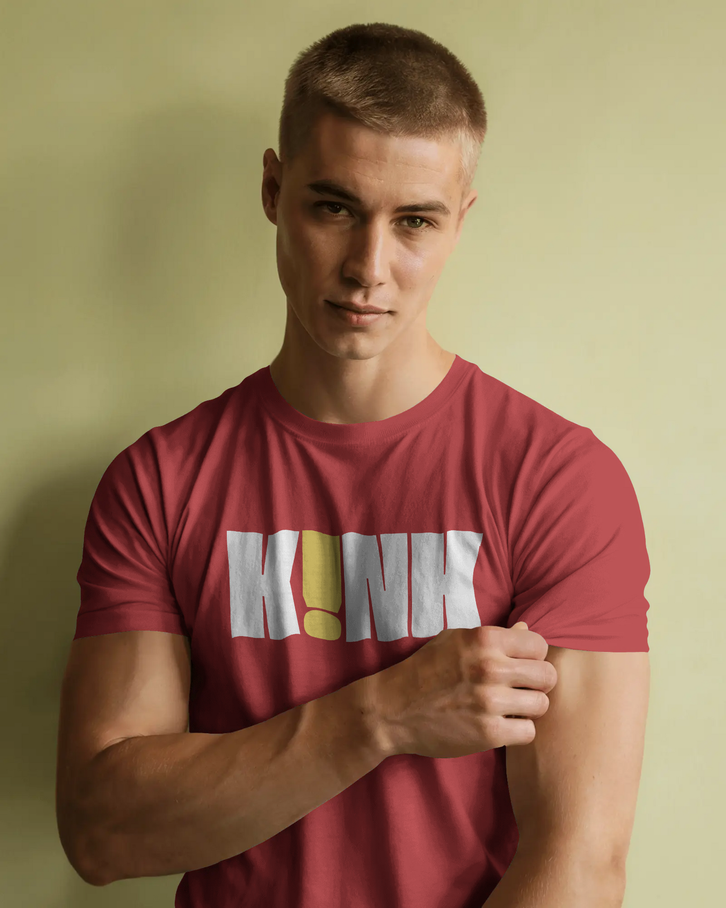 Man wearing a red t-shirt with 'KINK' printed on it against a plain background   Kink, LGBTQIA+, Queer