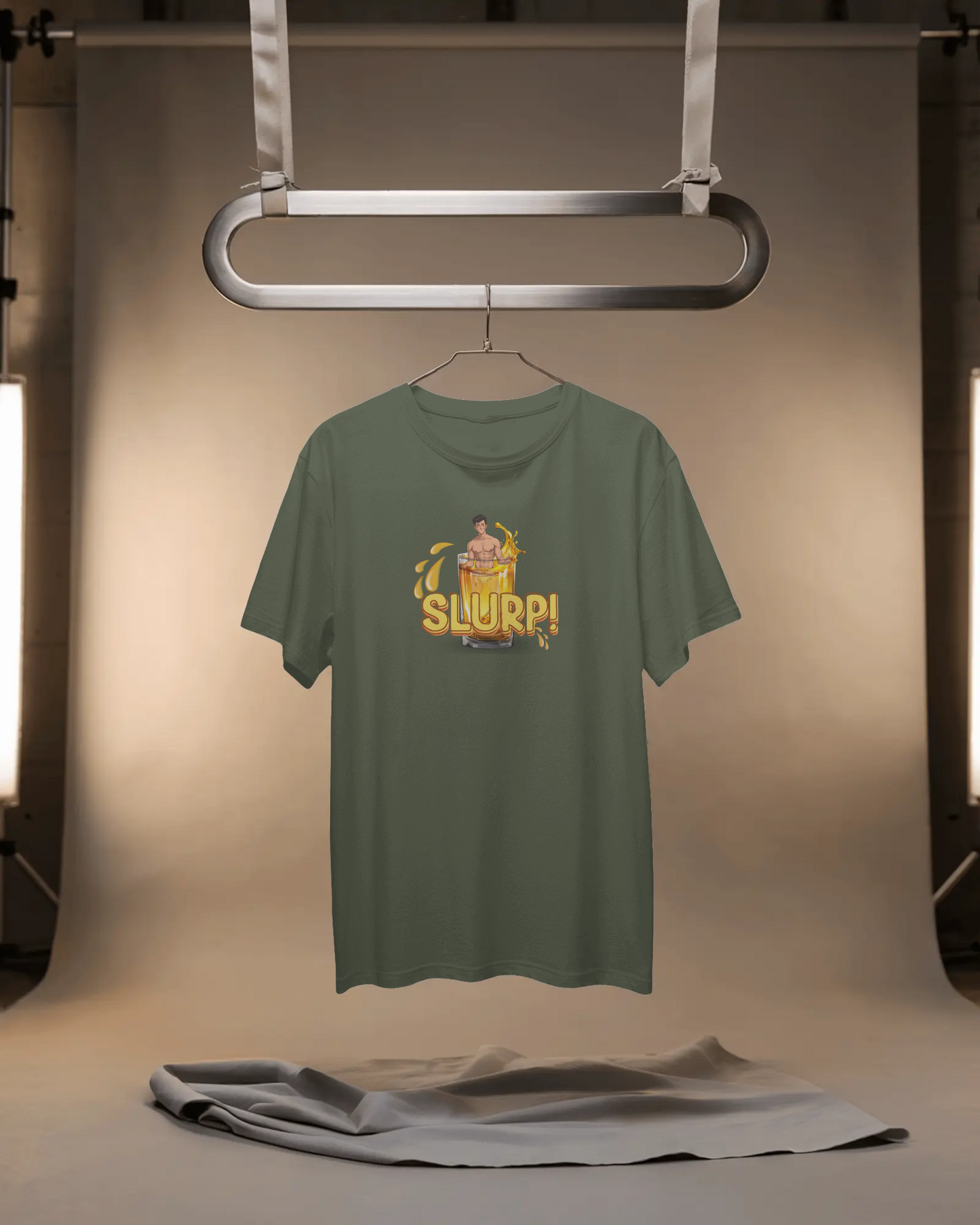 Green t-shirt with a graphic design on a hanger against a neutral background