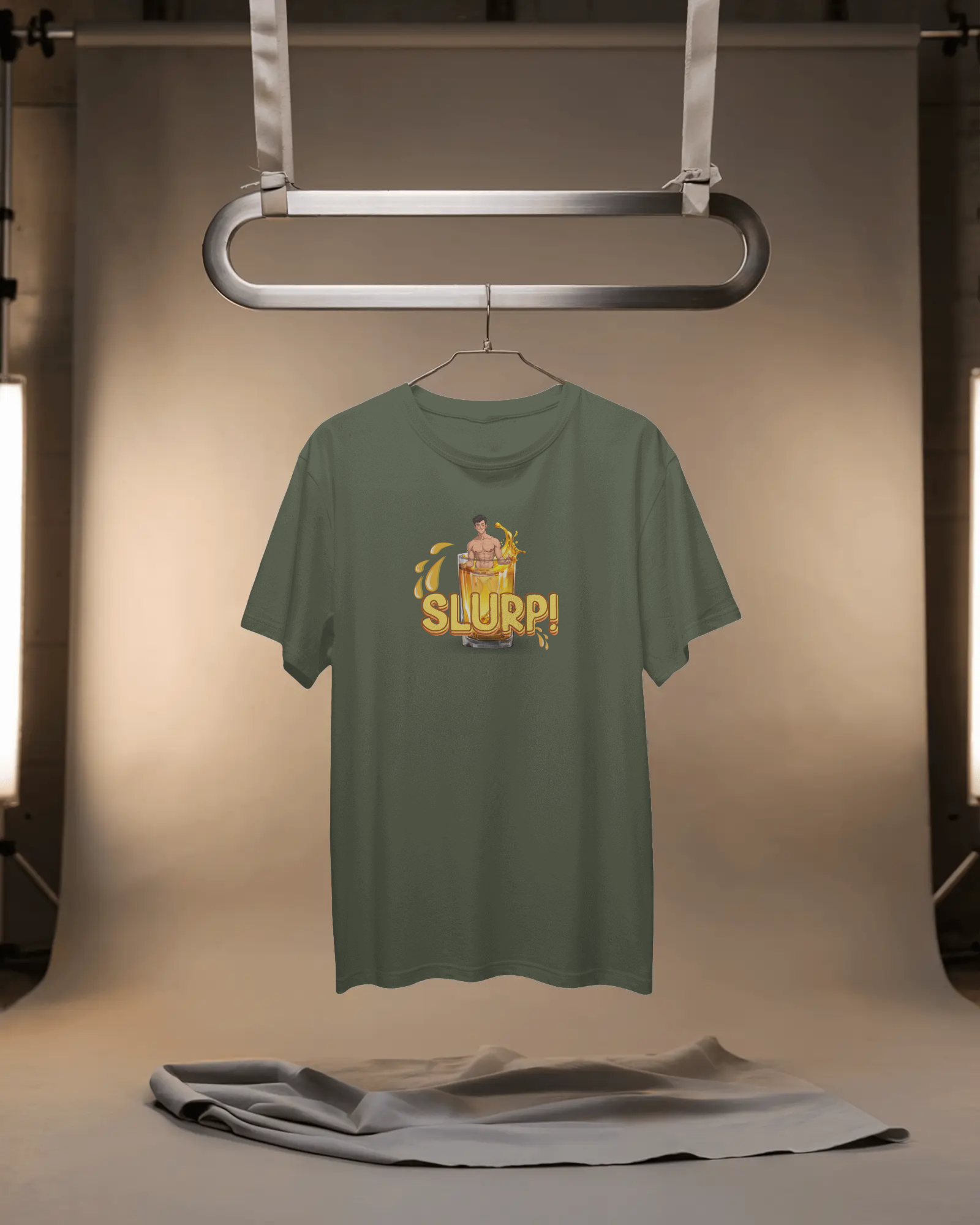 Green t-shirt with a graphic design on a hanger against a neutral background