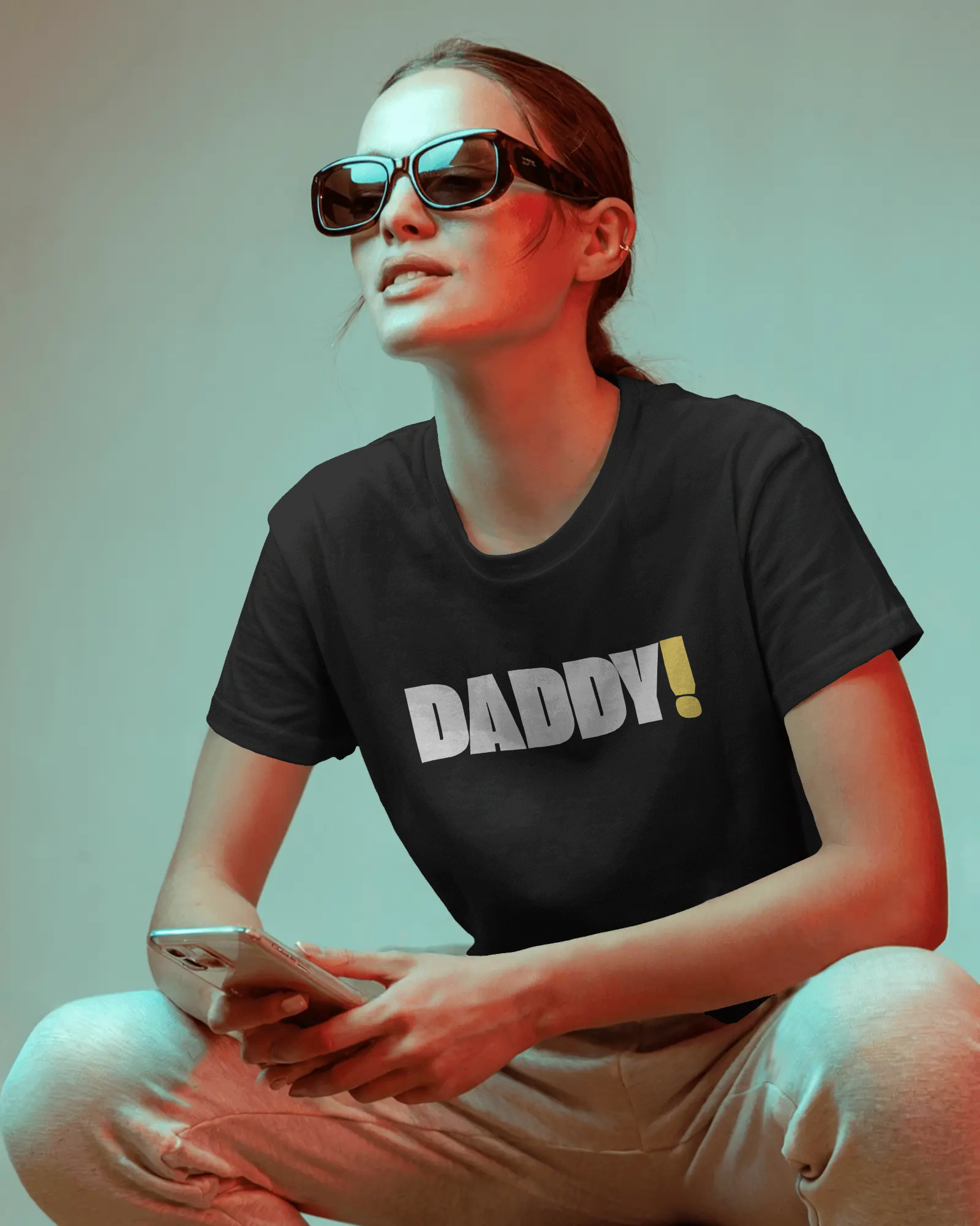 Man wearing a black t-shirt with 'DADDY!' text against a dark background LGBTQIA+ Kink Positive