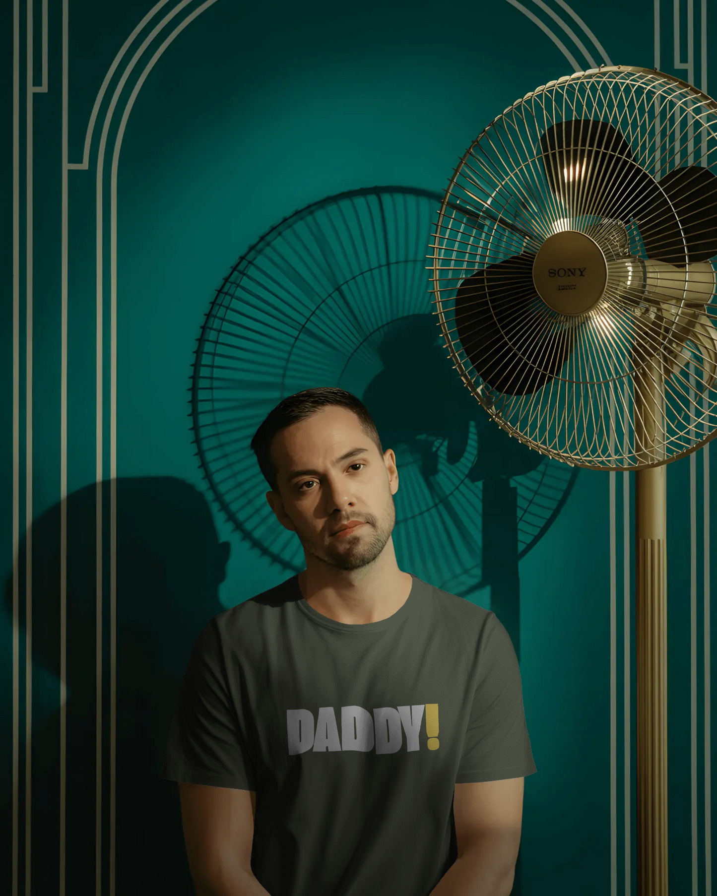 Man wearing a black t-shirt with 'DADDY!' text against a dark background LGBTQIA+ Kink Positive
