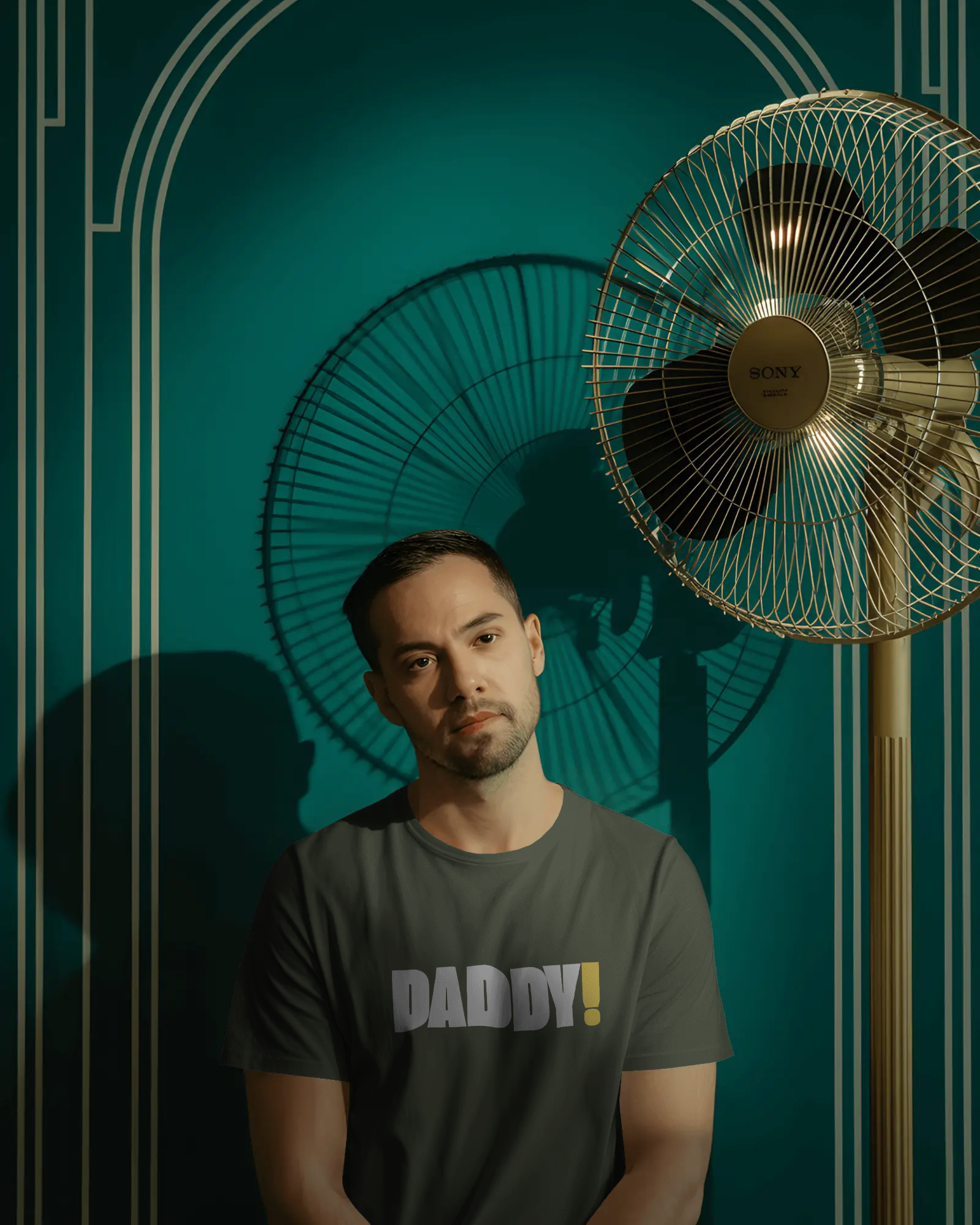 Man wearing a black t-shirt with 'DADDY!' text against a dark background LGBTQIA+ Kink Positive