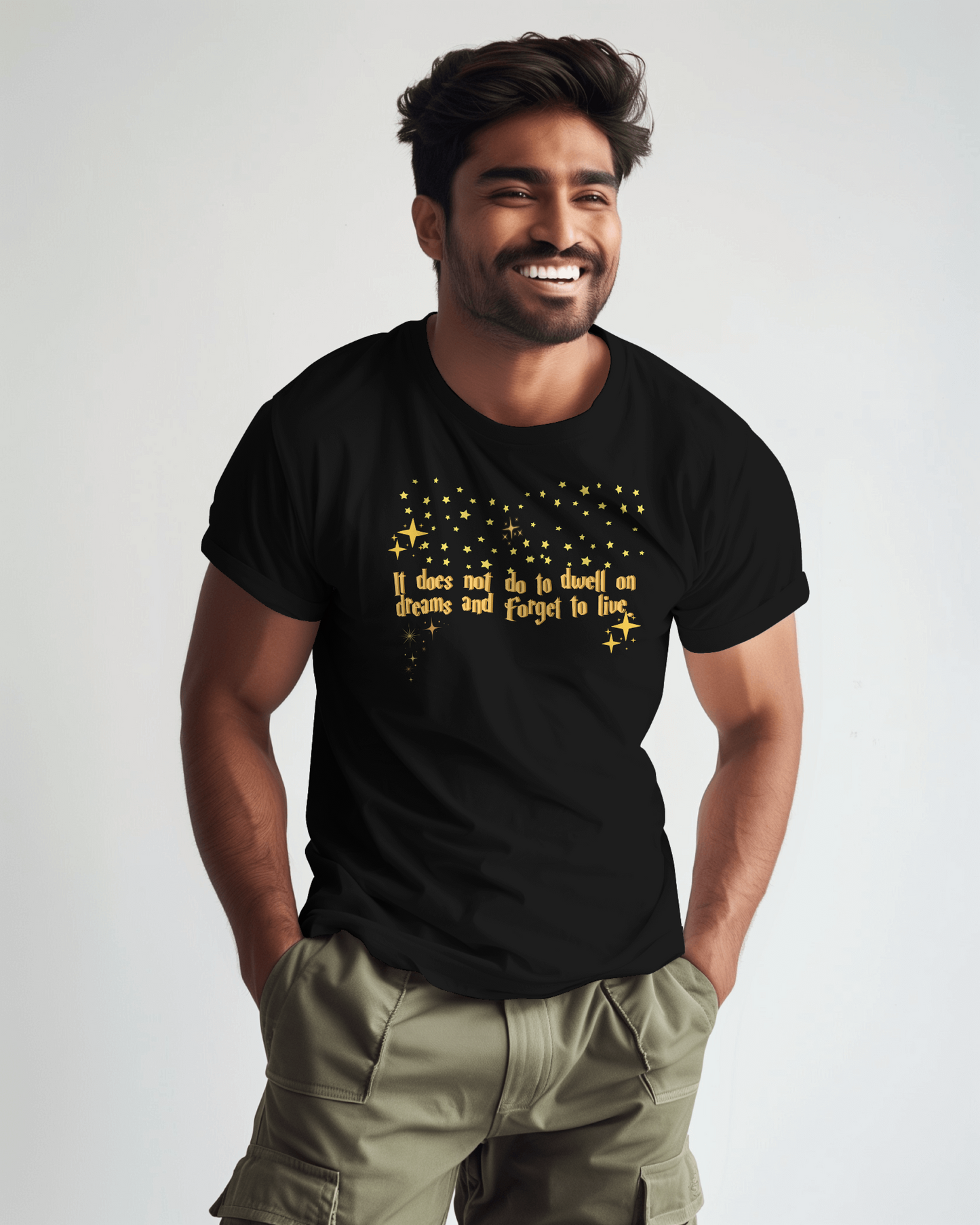 Man wearing a black t-shirt with yellow text and stars on a plain background, Dumbledore quote, harry potter