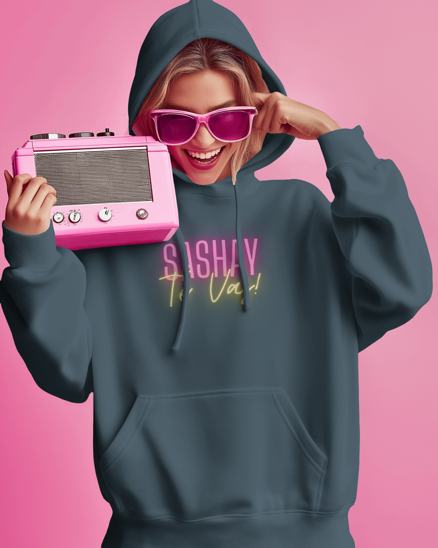 Person wearing a hoodie with text, holding a pink radio against a pink background  Drag Race Espana, Drag Race Spain, Rupaul's drag race, Drag queens, LGBT, Queer culture