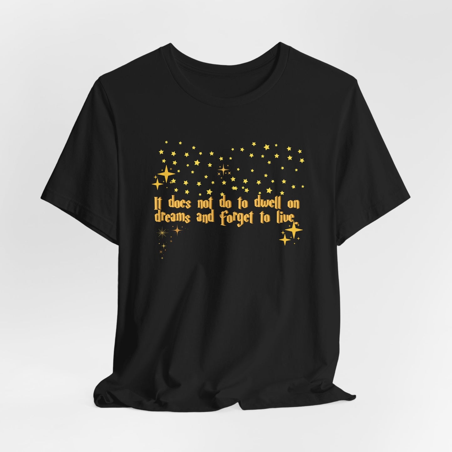 Black t-shirt with yellow text and star graphics on a white background, Dumbledore quote, harry potter
