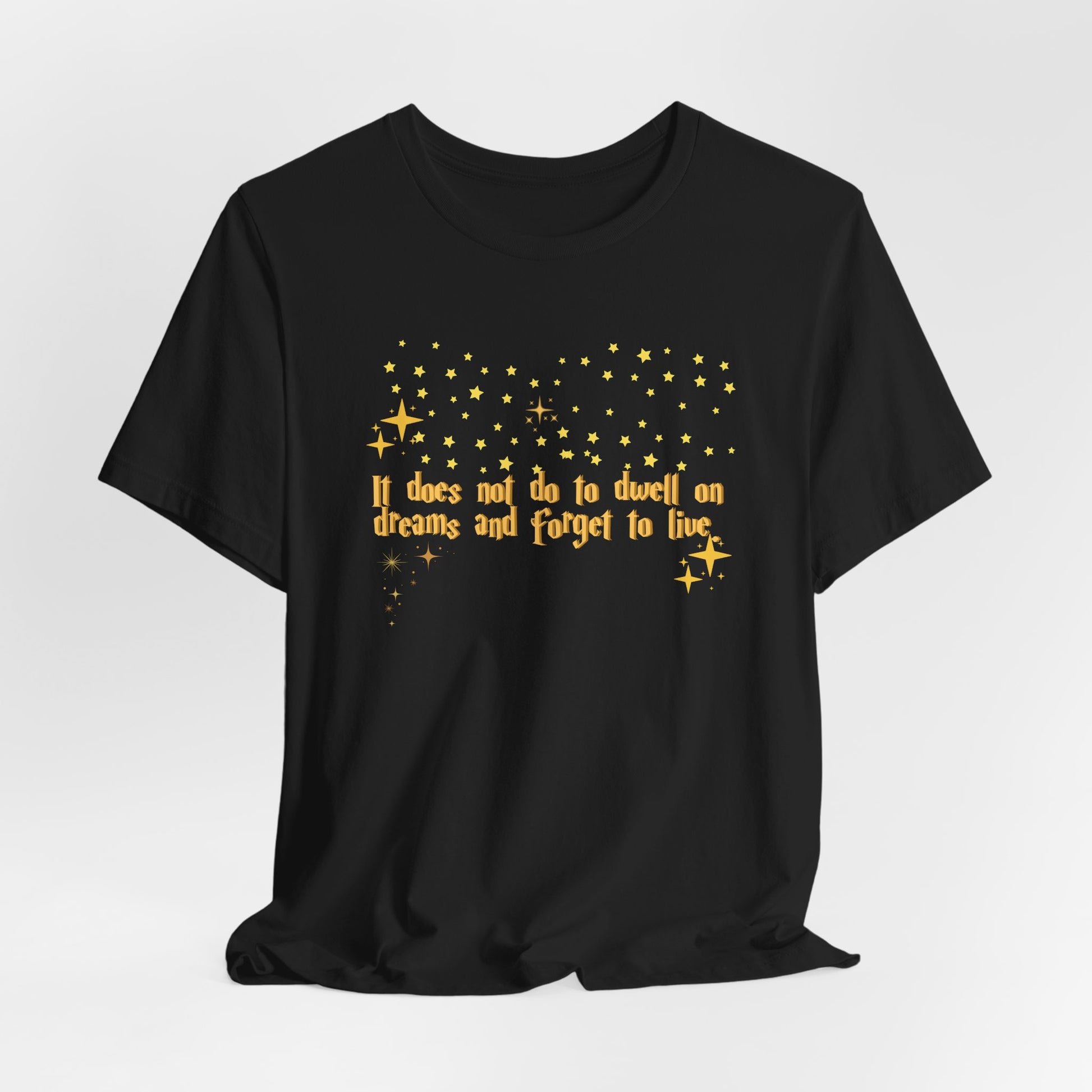 Black t-shirt with yellow text and star graphics on a white background, Dumbledore quote, harry potter
