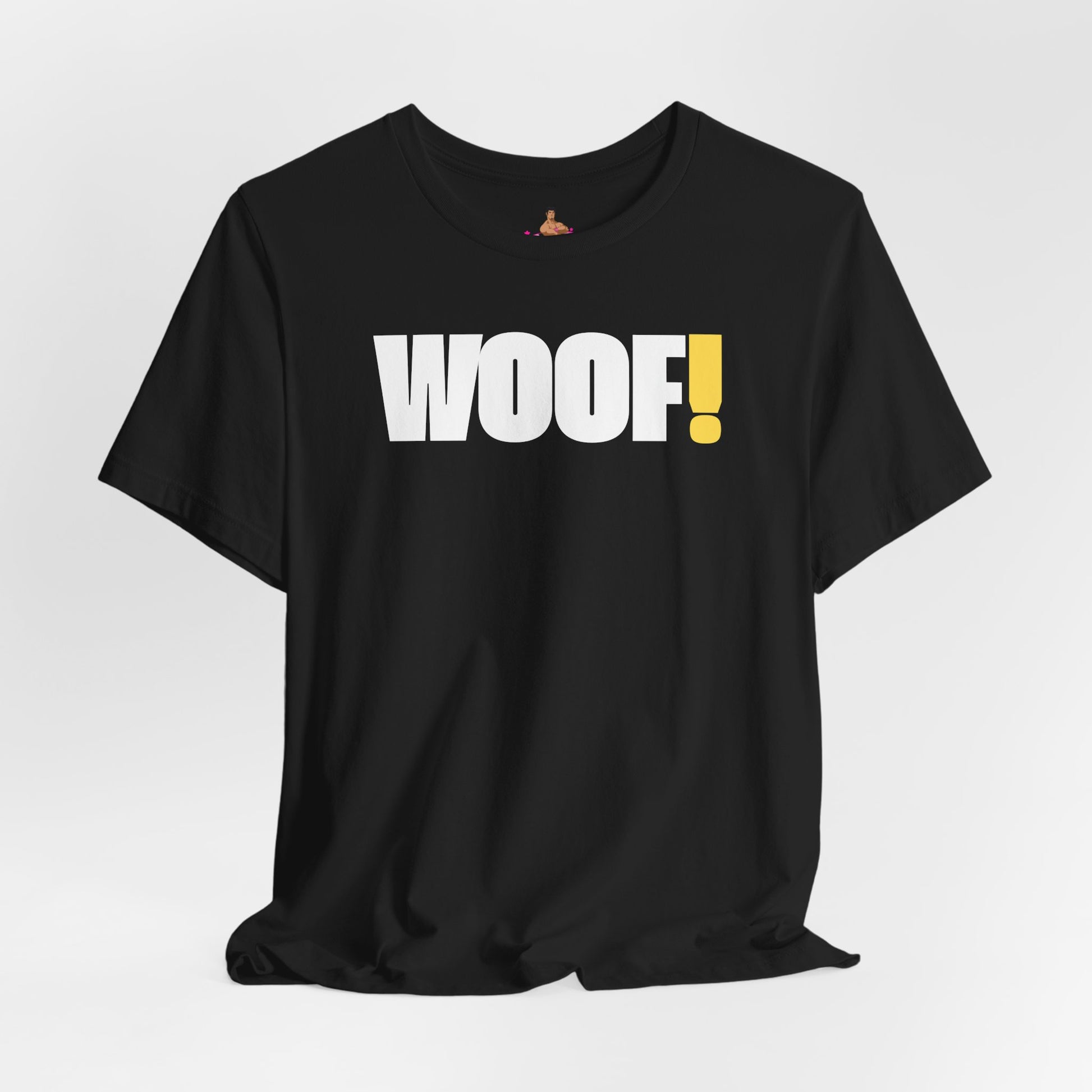Man wearing a black t-shirt with 'WOOF!' text against a dark background LGBTQIA+ QUEER, Kink Positive