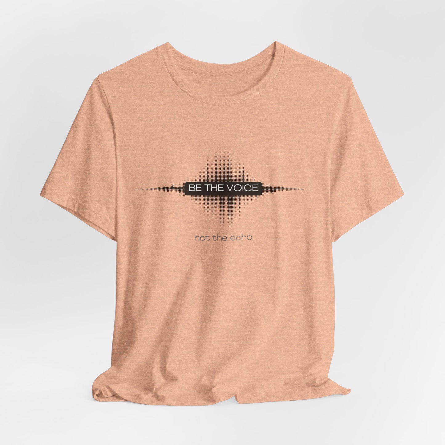 Peach t-shirt with 'Be the Voice, not the Echo' text on a light gray background