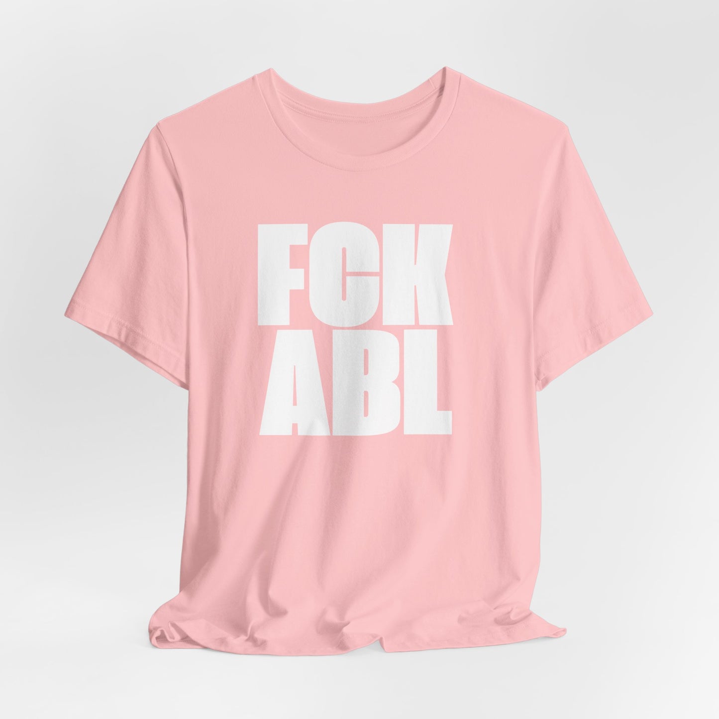 Pink t-shirt with white text on a light gray background